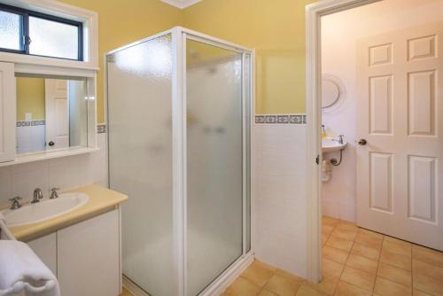 a bathroom with a shower and a sink at Waterside View in Augusta