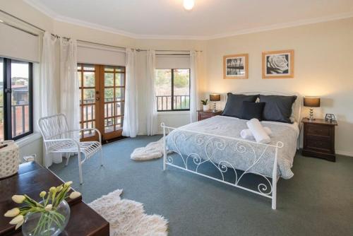 a bedroom with a bed and a balcony at Waterside View in Augusta