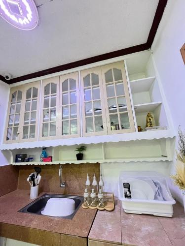 a kitchen with a sink and a counter top at Triple K Transient House in Butuan