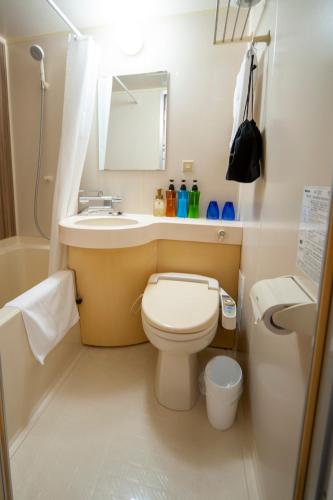 a small bathroom with a toilet and a sink at Hotel Il Fiore Kasai Annex in Tokyo