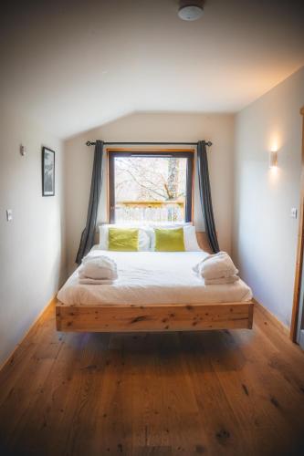 a bedroom with a large bed with a window at Eagle's Nest Connemara and Westport in Westport
