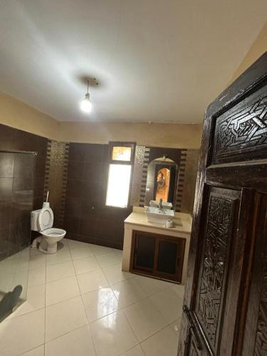 a bathroom with a toilet and a sink at chitoui in Ben Slimane