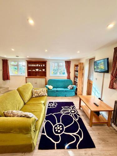 a living room with a couch and a table at Cosy stay within South Downs! in Southampton