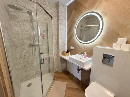 a bathroom with a shower and a toilet and a sink at Kwietny Stoczek 70 in Białowieża