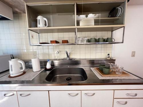a kitchen with a sink and a counter top at 北浜703 3ベッドルーム貸切 高松港近く 最大6名 in Takamatsu