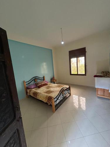 a bedroom with a bed in a room at chitoui in Ben Slimane