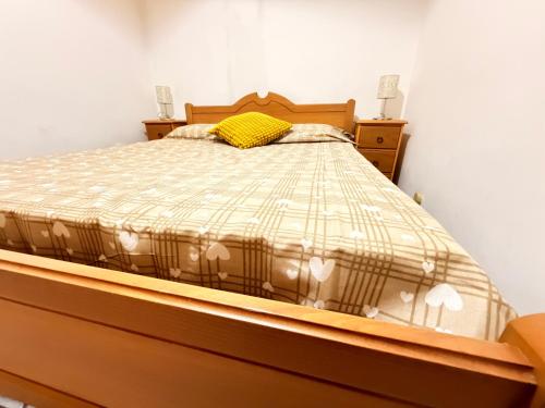 a bedroom with a bed with a yellow pillow on it at La Piccola Dimora Sul Mare in Gallipoli