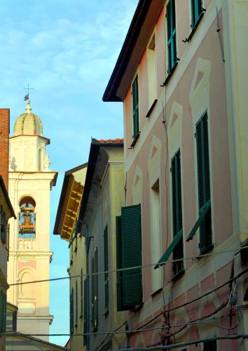 a building with a clock tower in the distance at Ca' di Beppe in Albenga