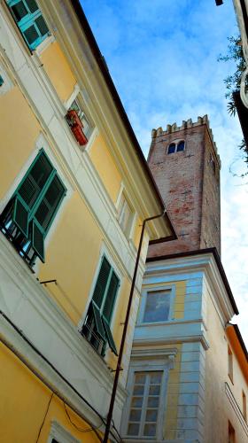 a yellow building with a tower on top of it at Ca' di Beppe in Albenga