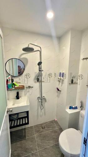 a bathroom with a shower and a toilet and a sink at Heaven Hostel in Ho Chi Minh City