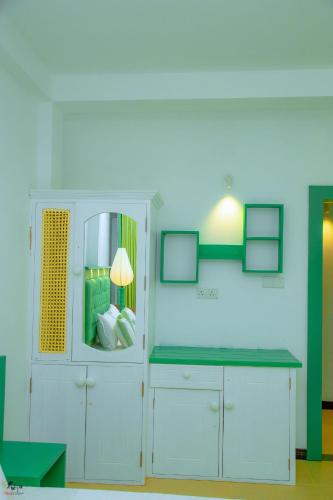 a room with a white cabinet with a mirror at Norea Sands in Bentota