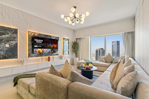 a living room with a large couch and a tv at Desert Key - Gate Tower Apartments in Abu Dhabi