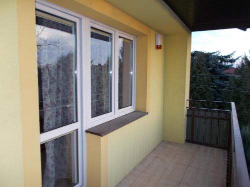 a balcony of a house with two windows at Willa Poniatowskiego in Grodzisk Mazowiecki