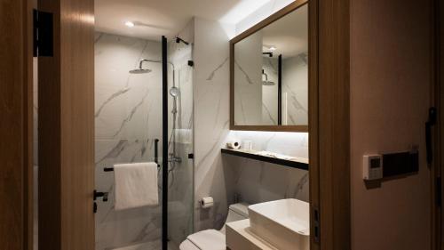 a bathroom with a shower and a toilet and a sink at Forest View Studio at Laya Resort in Layan Beach