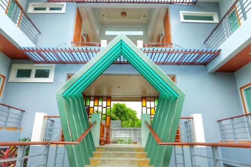 a stairway leading up to a building with a green doorway at Princess River Kwai Hotel in Kanchanaburi