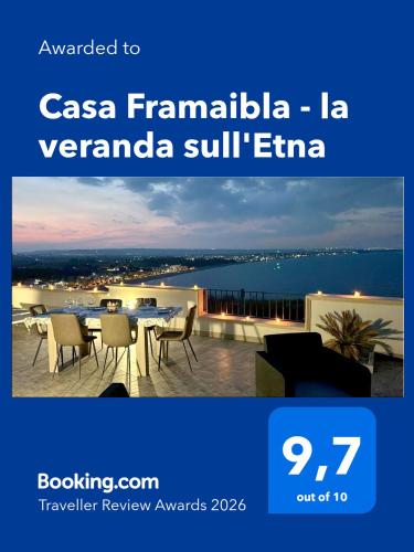 a poster for a hotel with a table and chairs at Casa Framaibla - la veranda sull'Etna in Augusta