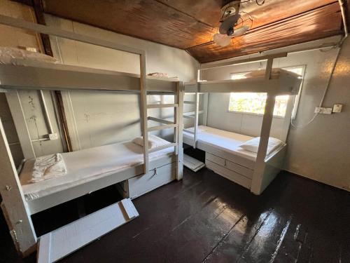 a room with three bunk beds and a window at Ohlala Guesthouse in Perhentian Islands