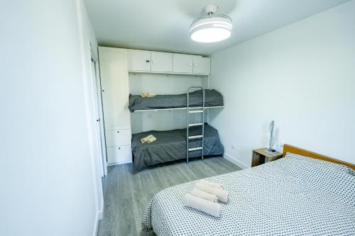 a bedroom with a bed and a bunk bed at Mountain Home in La Pinilla