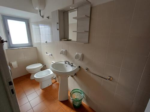 a bathroom with a toilet and a sink at Bellavista in Badia Prataglia