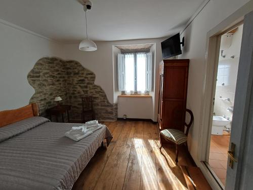a bedroom with a bed and a stone wall at Bellavista in Badia Prataglia