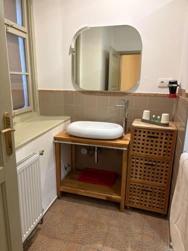 a bathroom with a sink and a mirror at Hotel Kapitán in Žatec