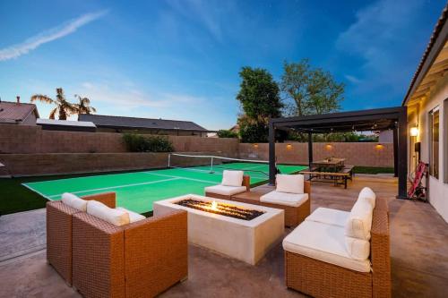 a patio with chairs and a pool with a table at Desert Escape - Private Pool - Spa in Indio