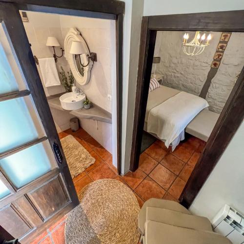 a view of a room with a bed and a mirror at Casa Rural Concejos in San Román de Cameros