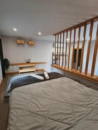 a bedroom with a large bed and a staircase at Casa do Tapado in Amarante