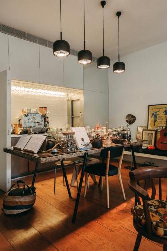 a dining room with a table with chairs and lights at Rosário Suites Townhouse in Porto