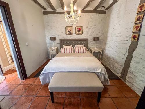 a bedroom with a bed with pink pillows at Casa Rural Concejos in San Román de Cameros