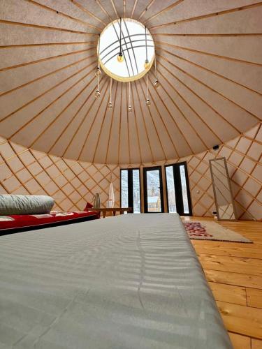 a large room with a bed in a yurt at Отель 3 in Kurmenty