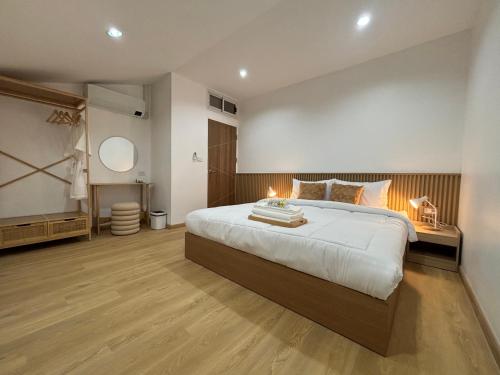 a bedroom with a large bed with lights on it at Muji house Chiangmai 01 in Chiang Mai