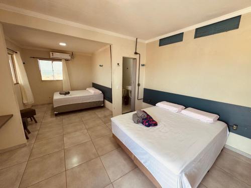a bedroom with two beds in a room with at Pousada beira mar e sol in Tibau