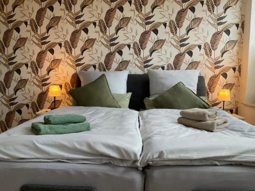 a bed with two towels on top of it at Ferienwohnung, Apartment Schwertherz in Wulfsen