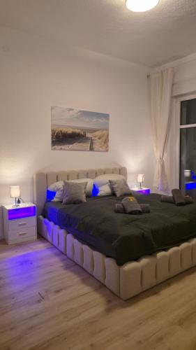 a bedroom with a large bed with blue lighting at Altstadtnähe Sauna-Infrarot 2 Schlafzimmer in Koblenz