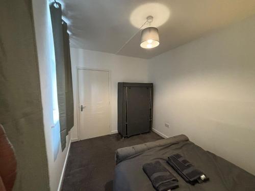 a room with a bed and a door in it at Doncaster City Centre Immaculate 1 Bedroom flat in Doncaster