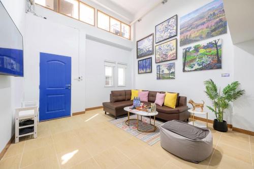 a living room with a couch and a blue door at Chummy House Khaosan 10-Min, Peace Haven in Bangkok
