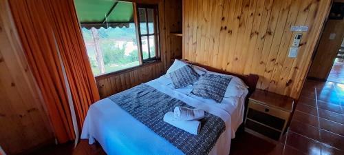 a bedroom with a bed in a wooden room at Riberas del Parana in Wanda