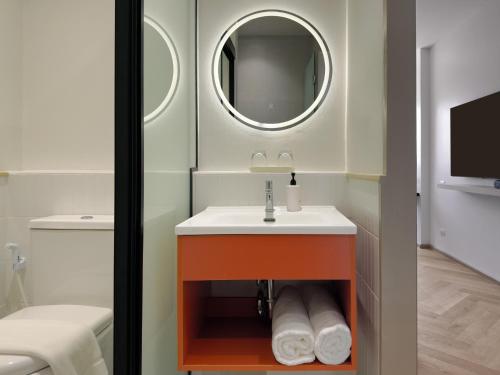 a bathroom with a sink and a mirror at Fortune D Hotel Loei in Loei