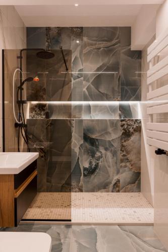 a bathroom with a shower and a sink at Cherry Apartments in Iaşi