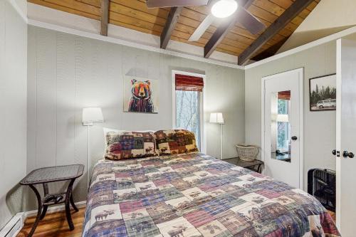 a bedroom with a bed with a quilt on it at Sugar High in Sugar Mountain