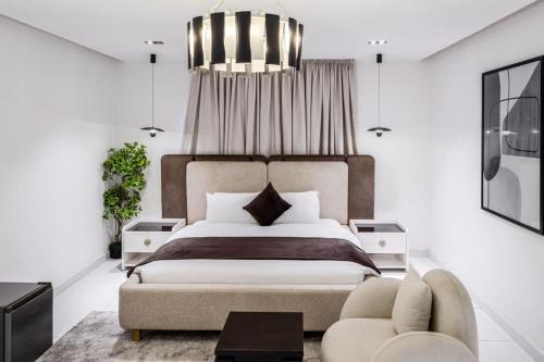 a bedroom with a large bed and a chair at Eterniti by Amber in Lagos