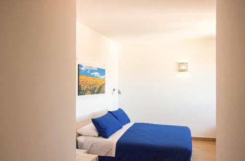 a bedroom with a bed with blue sheets at Agriturismo San Germano in San Vittorino