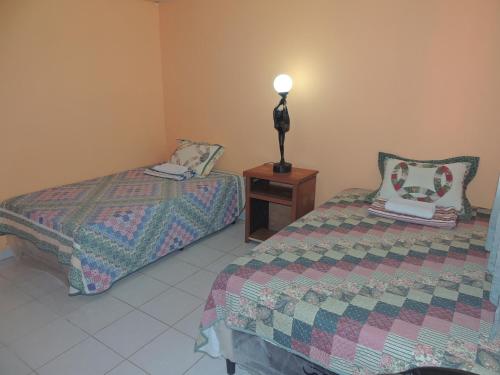 a bedroom with two beds and a lamp on a table at Hostal la Majada la Vida es Bella in San José La Majada