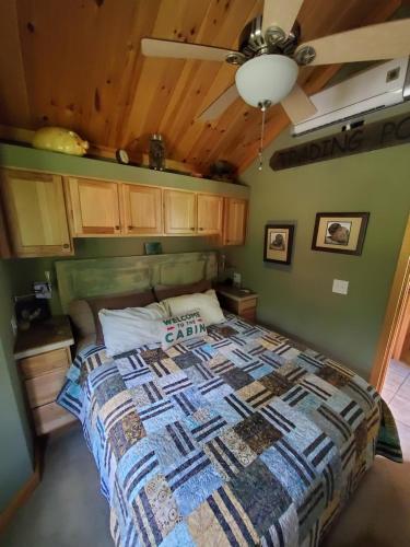a bedroom with a bed and a ceiling at Bison Farm - Cabin "Vieja" in Culpeper