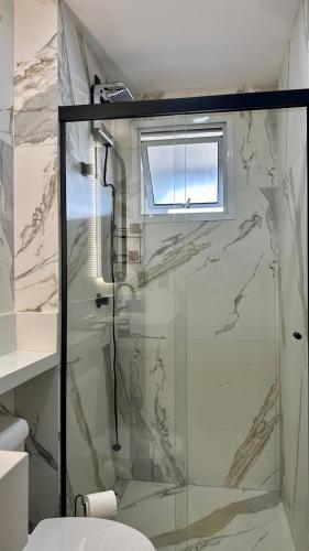 a bathroom with a shower with a glass door at Studio Red 10 - Sorocaba in Sorocaba