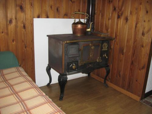 an old wood stove with a pot on top of it at bruno piller hoffer in Sappada