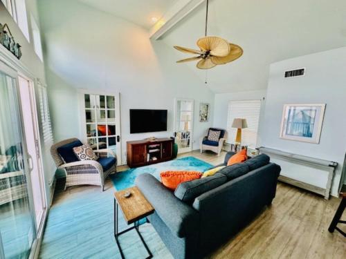 a living room with a couch and a tv at Shipwrecked Getaway For 6 in Galveston