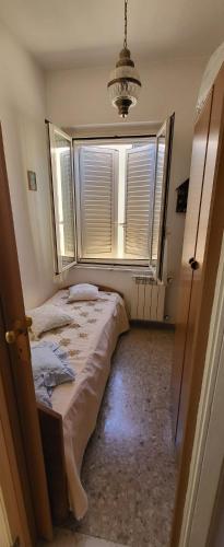 a bedroom with a bed and a large window at Casamare in Roseto degli Abruzzi