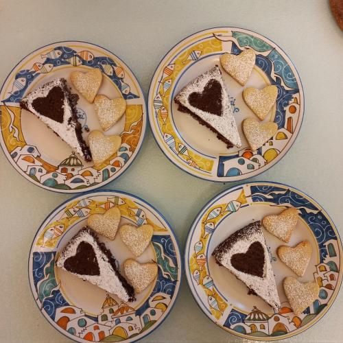 three plates with three slices of cake on them at B&B Vietri 360 in Vietri sul Mare